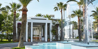 Familienhotel - Griechenland - Die grünen Gärten des Resorts und ein
wunderschön gestalteter Eingang heißen Sie herzlich Willkommen - Grecotel Creta Palace
